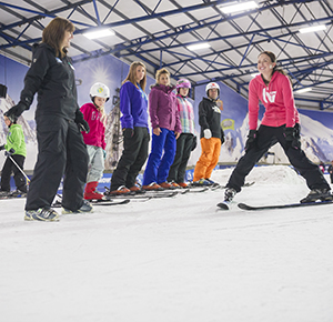 An instructor shows a family how to ski at the SnowDome, Staffordshire